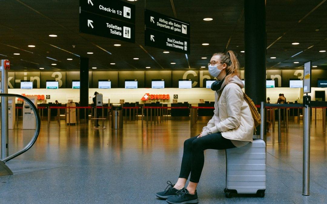 Health crisis and tourist behaviour - women sitting at the airport